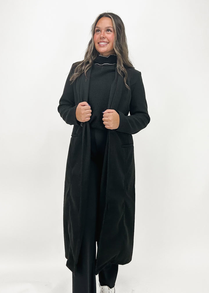 Women's long open-face coat in black and grey color block design, featuring a sleek silhouette and versatile style for effortless layering.