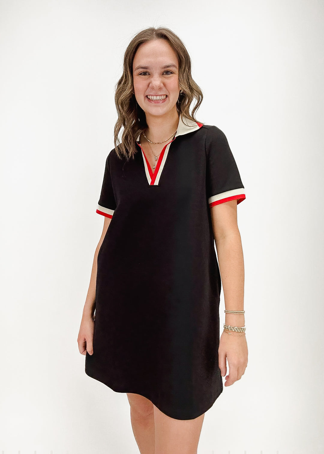 black polo mini dress with red and white collar and sleeve accents