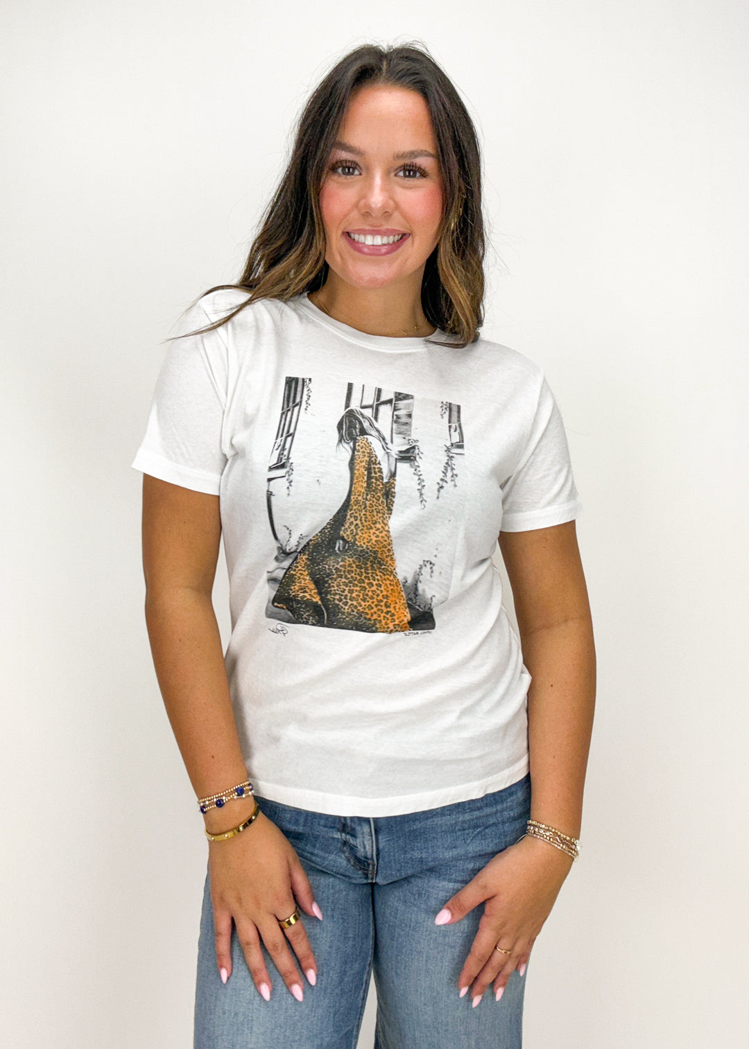 Woman wearing a white t-shirt with a graphic design 