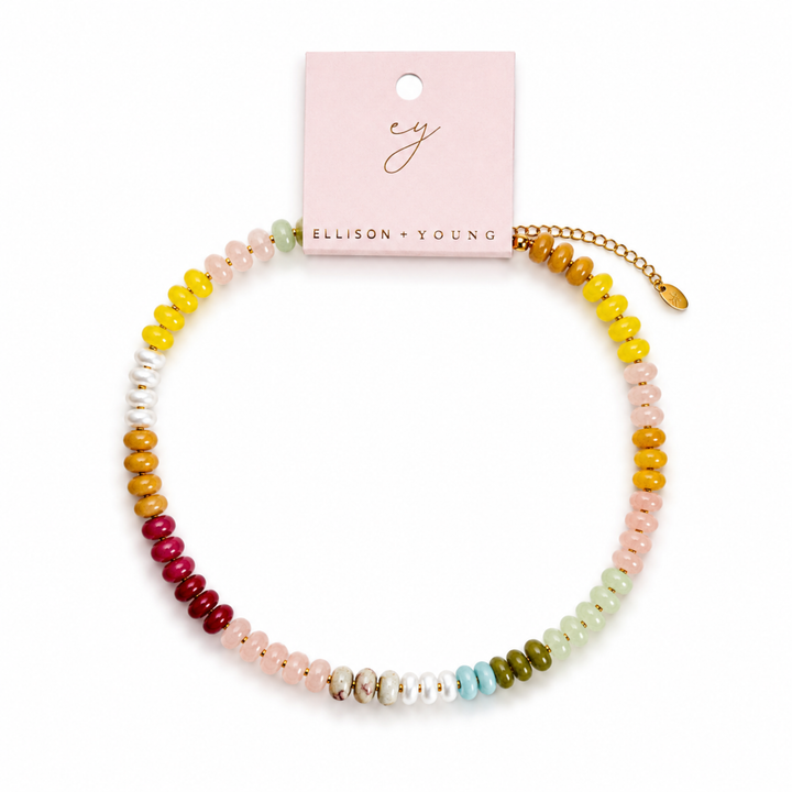Colorful beaded bracelet on a white background with Ellison + Young packaging.