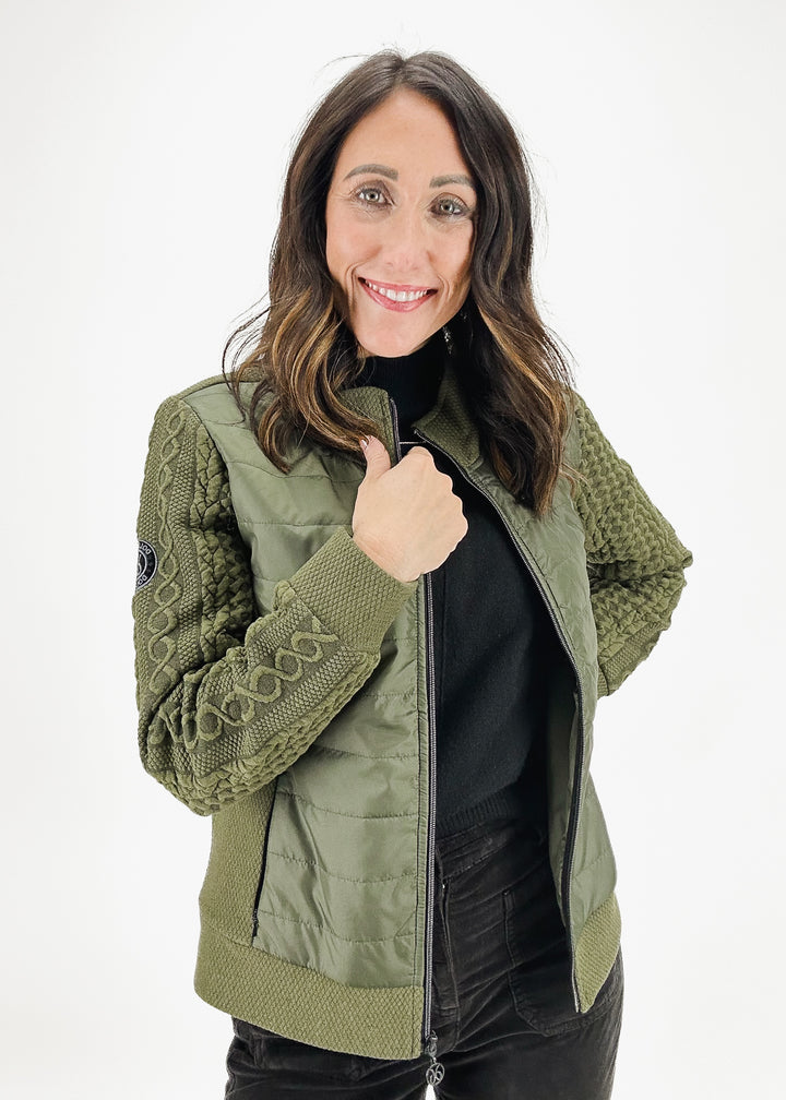 Women's Dolcezza Madelyn jacket in khaki green featuring a mixed-material design with woven cable knit sleeves and quilted body, offering both style and warmth.