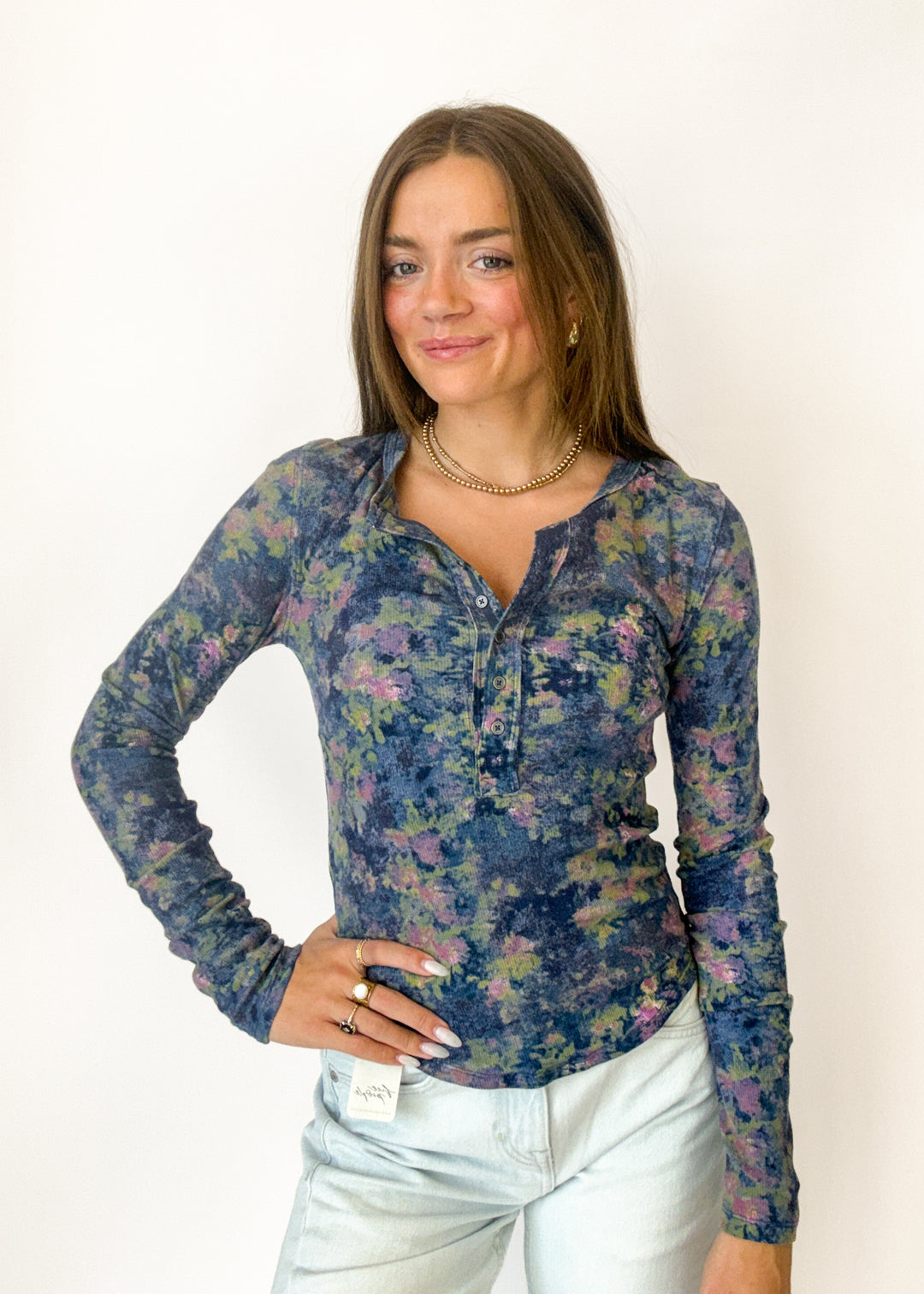 Woman wearing a blue floral henley long sleeve top