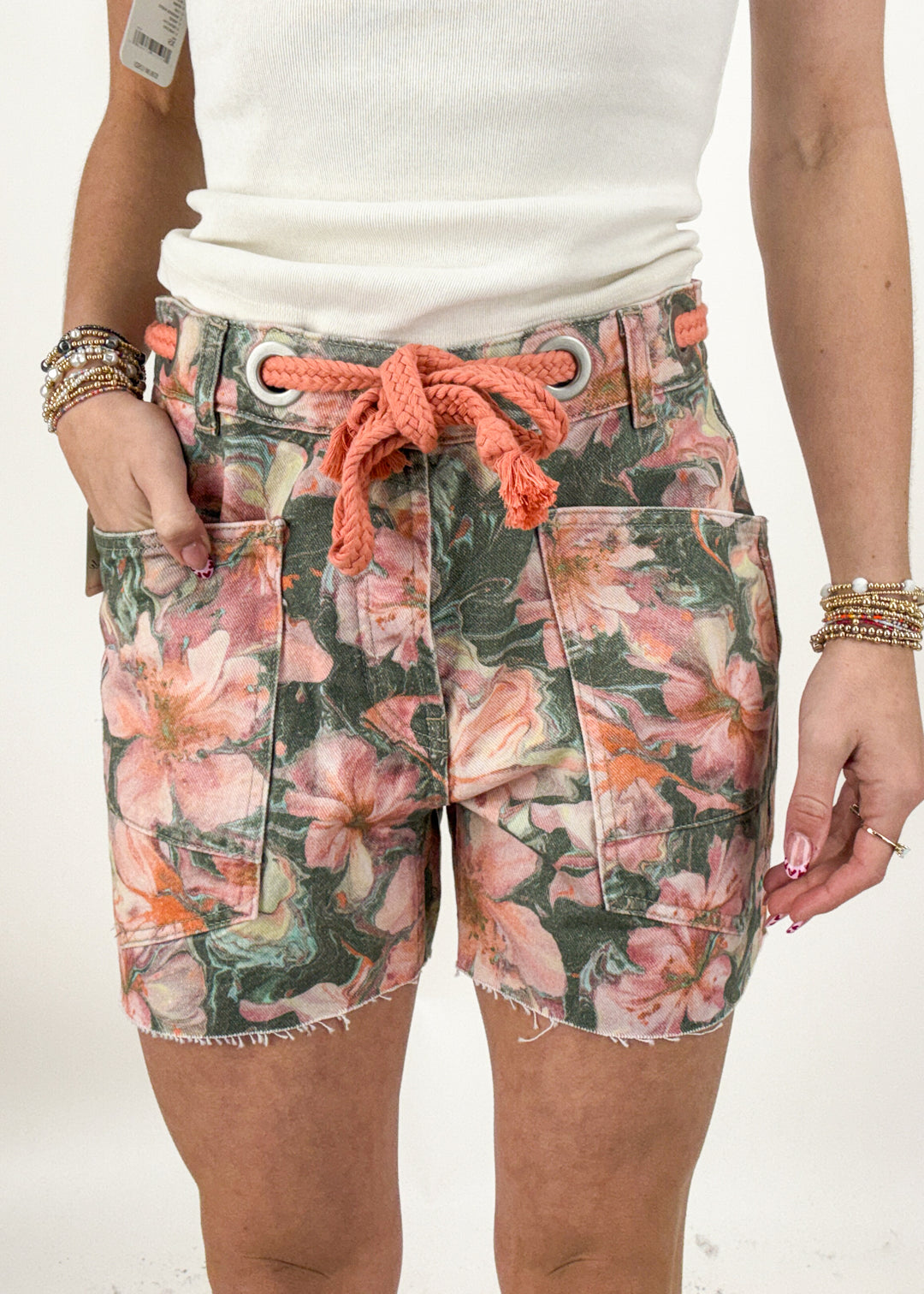 Floral shorts with a drawstring waistband worn by a person on a white background