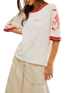 white oversized tee with red cuff and neckline details and embroidered floral sleeve details
