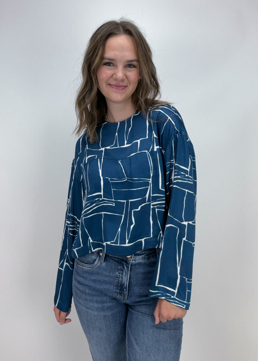 blue and white abstract print long sleeve top