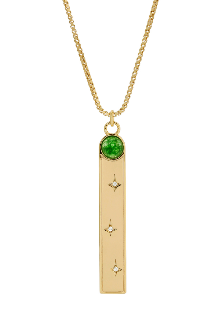 A gold pendant necklace featuring a rectangular charm with a green stone at the top and star-shaped accents from Leeada's Aether collection.