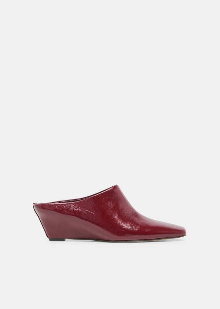A single burgundy leather wedge mule shoe with a pointed toe, shown in profile against a light gray background.
