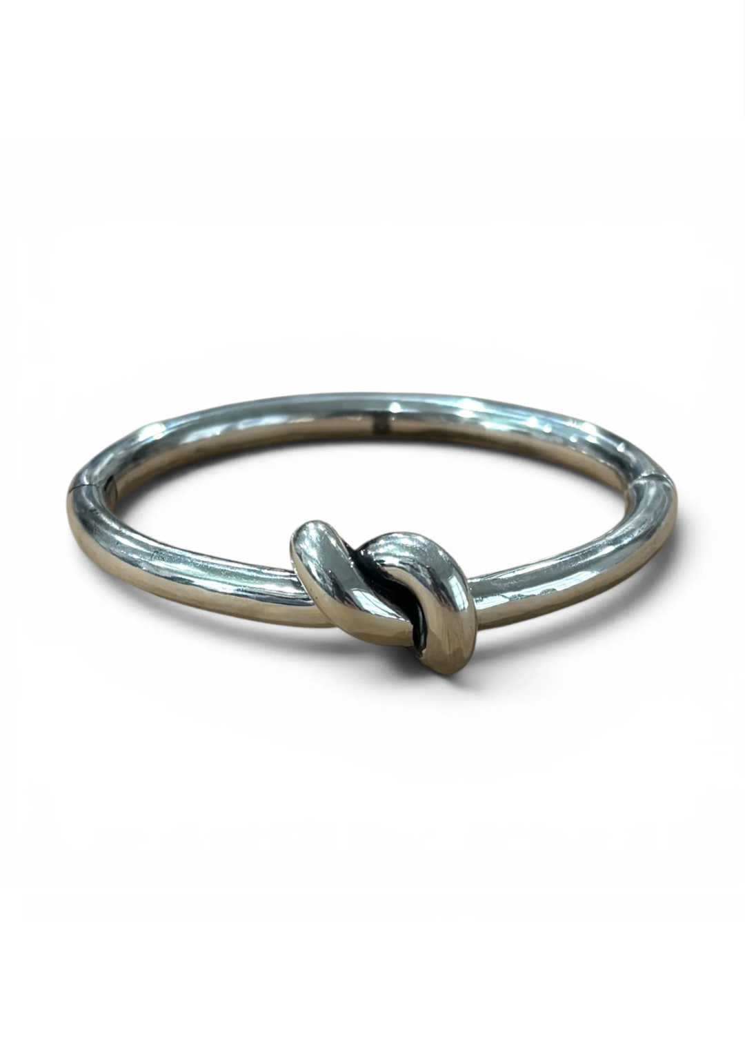 Silver toned bracelet with knot in the front and center. 