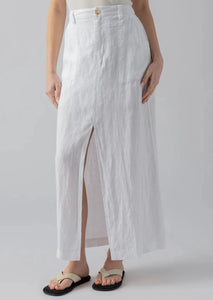 white linen maxi skirt with slit down the front, belt loops, and simple light tortoise button