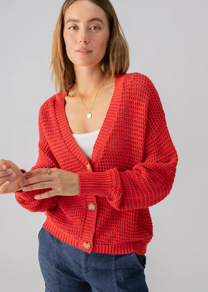 red knit cardigan with blonde tortoise buttons