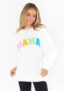 white oversized crew neck sweatshirt with "mama" written in multicolor varsity letters