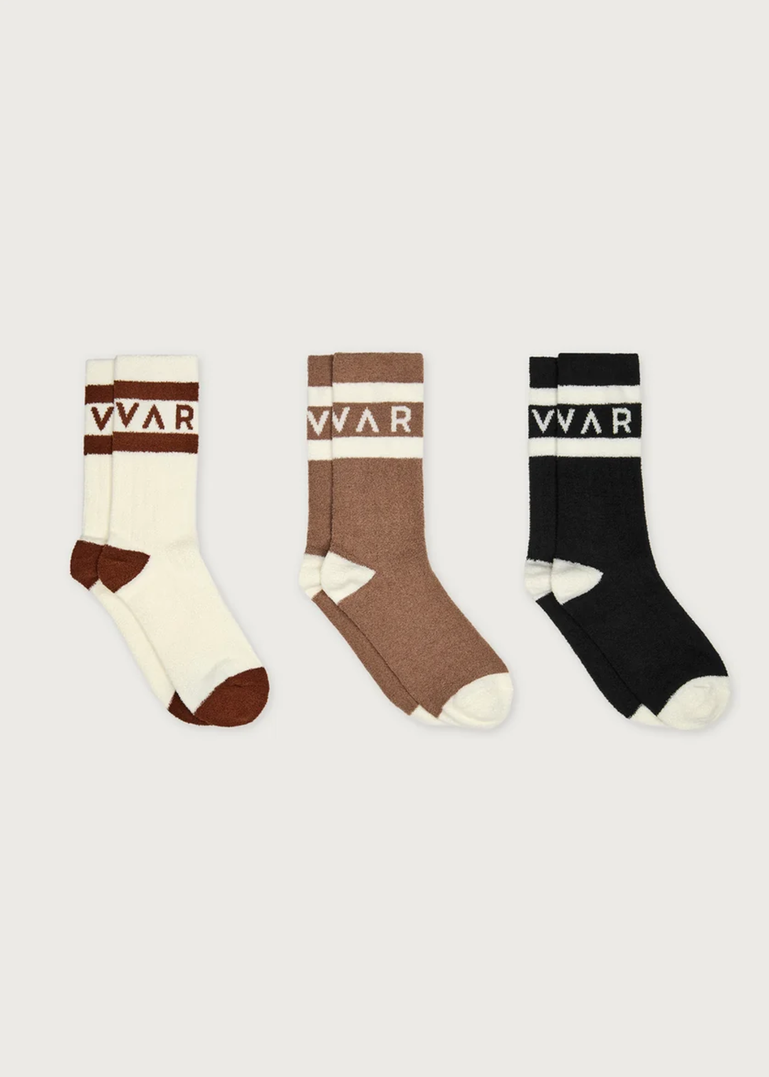 Three pairs of crew socks displayed side-by-side on a light gray background. The left pair is cream and brown, the middle pair is brown and cream, and the right pair is black and cream.