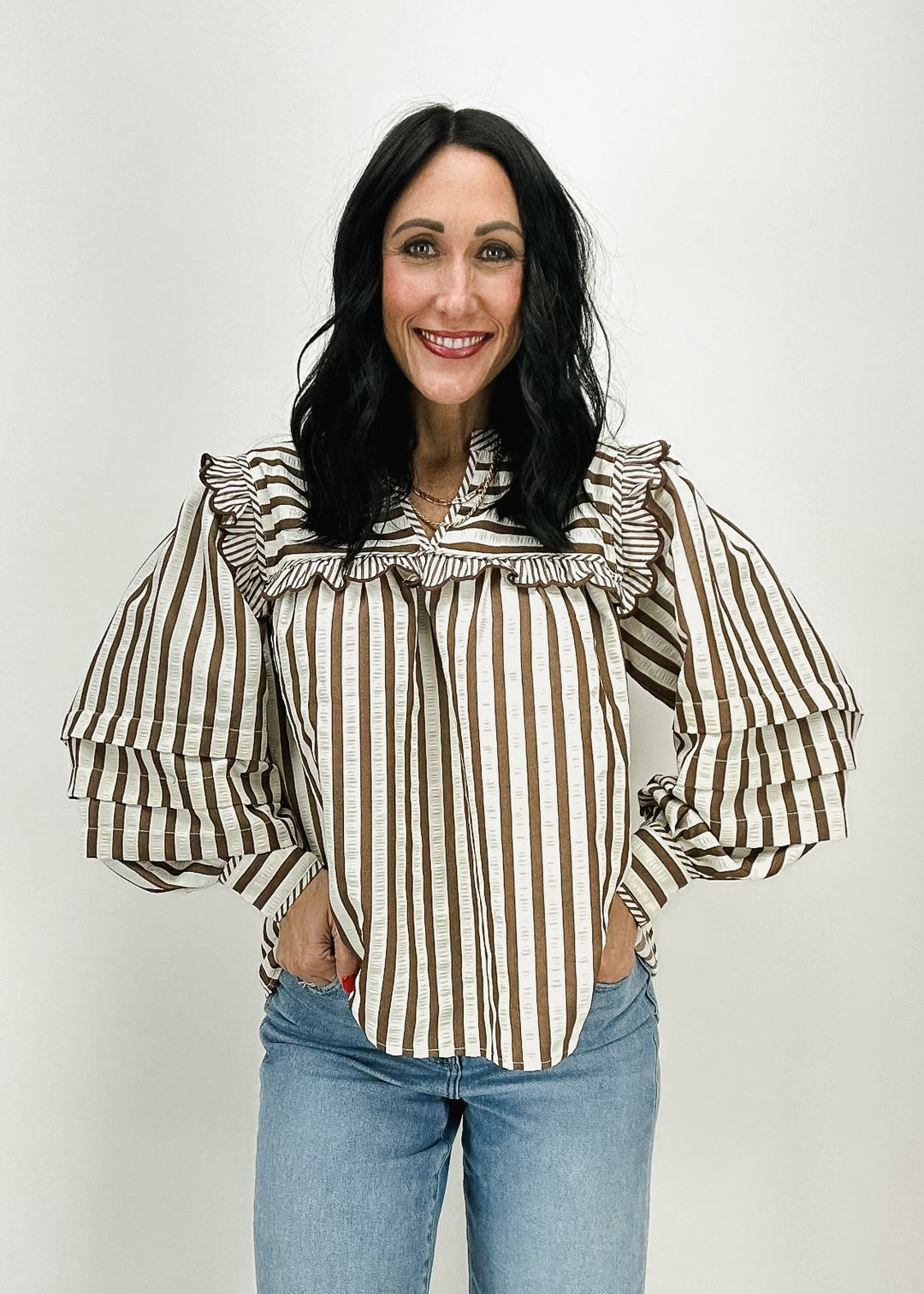 Women's brown and white striped top with ruffle collar and voluminous sleeves