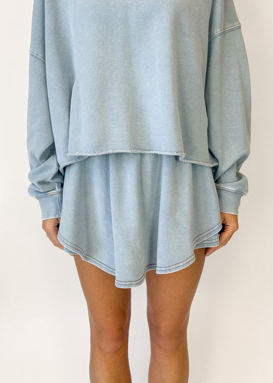 Light blue oversized sweatshirt and shorts set on a plain background