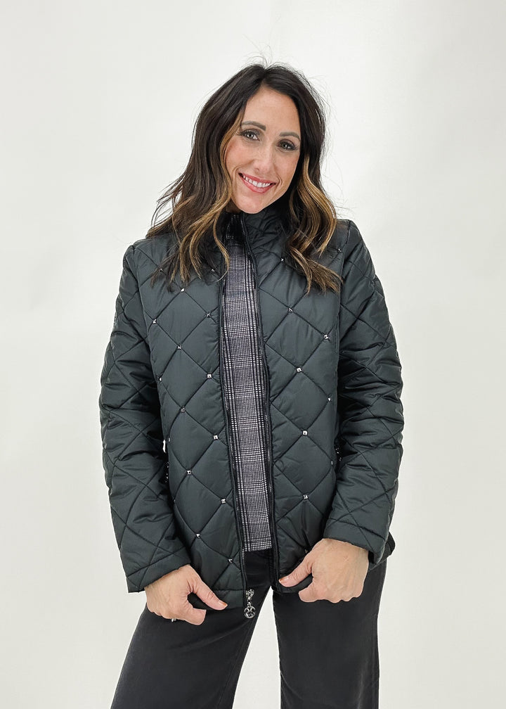 Women's black quilted winter puffer jacket by Dolcezza, featuring silver stud details and a cozy design for added warmth.