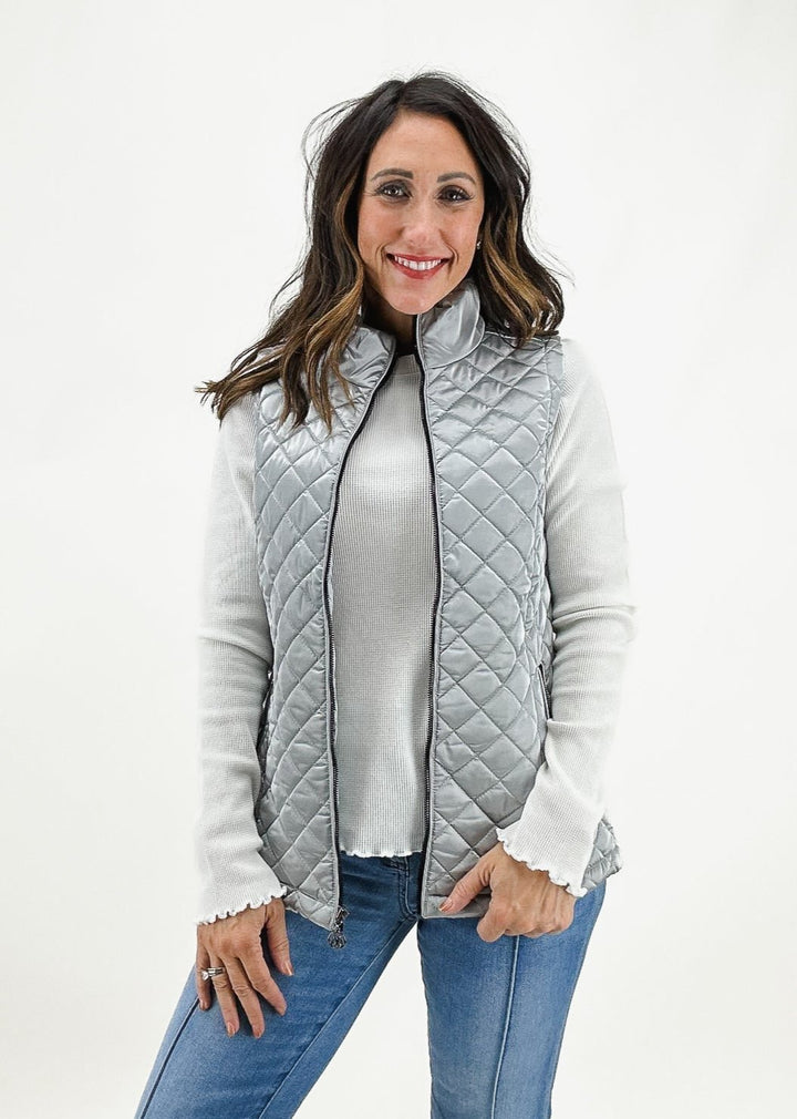 Women's silver quilted zip-front vest by Dolcezza, featuring a stylish and lightweight design perfect for layering.