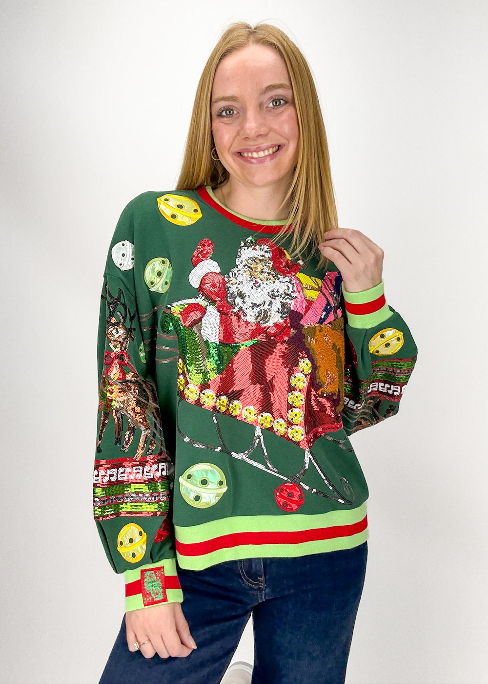 Person wearing a colorful Christmas-themed sweater with various designs 