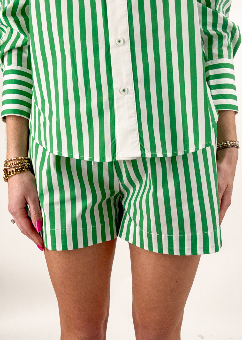 Woman wearing green and white stripe shorts