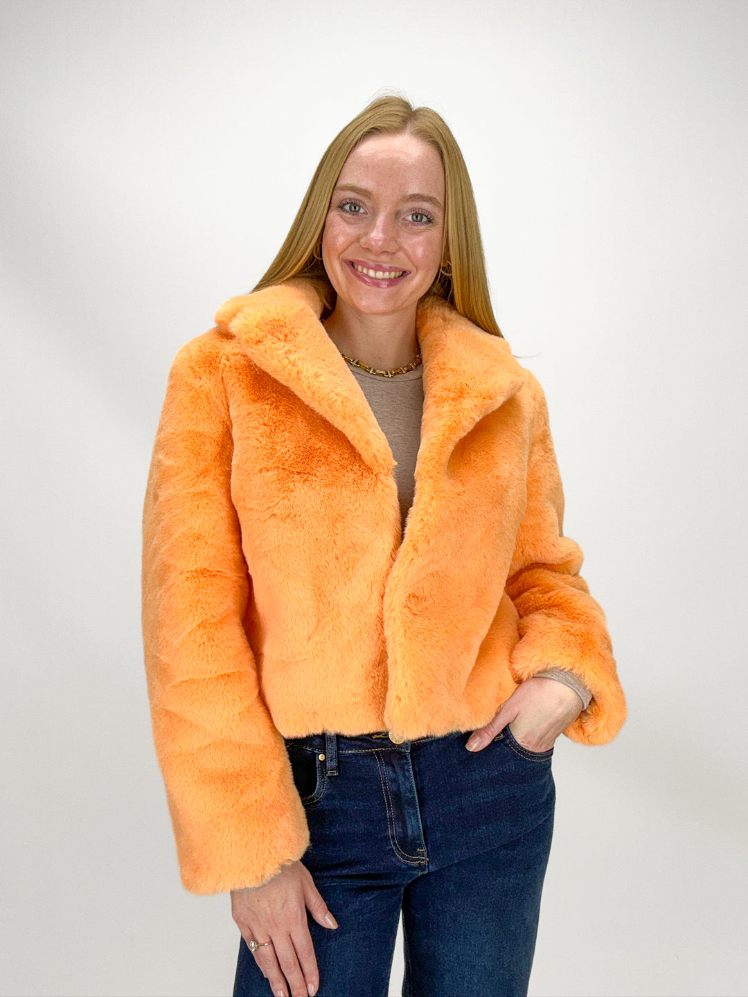 Person wearing an orange faux fur jacket 