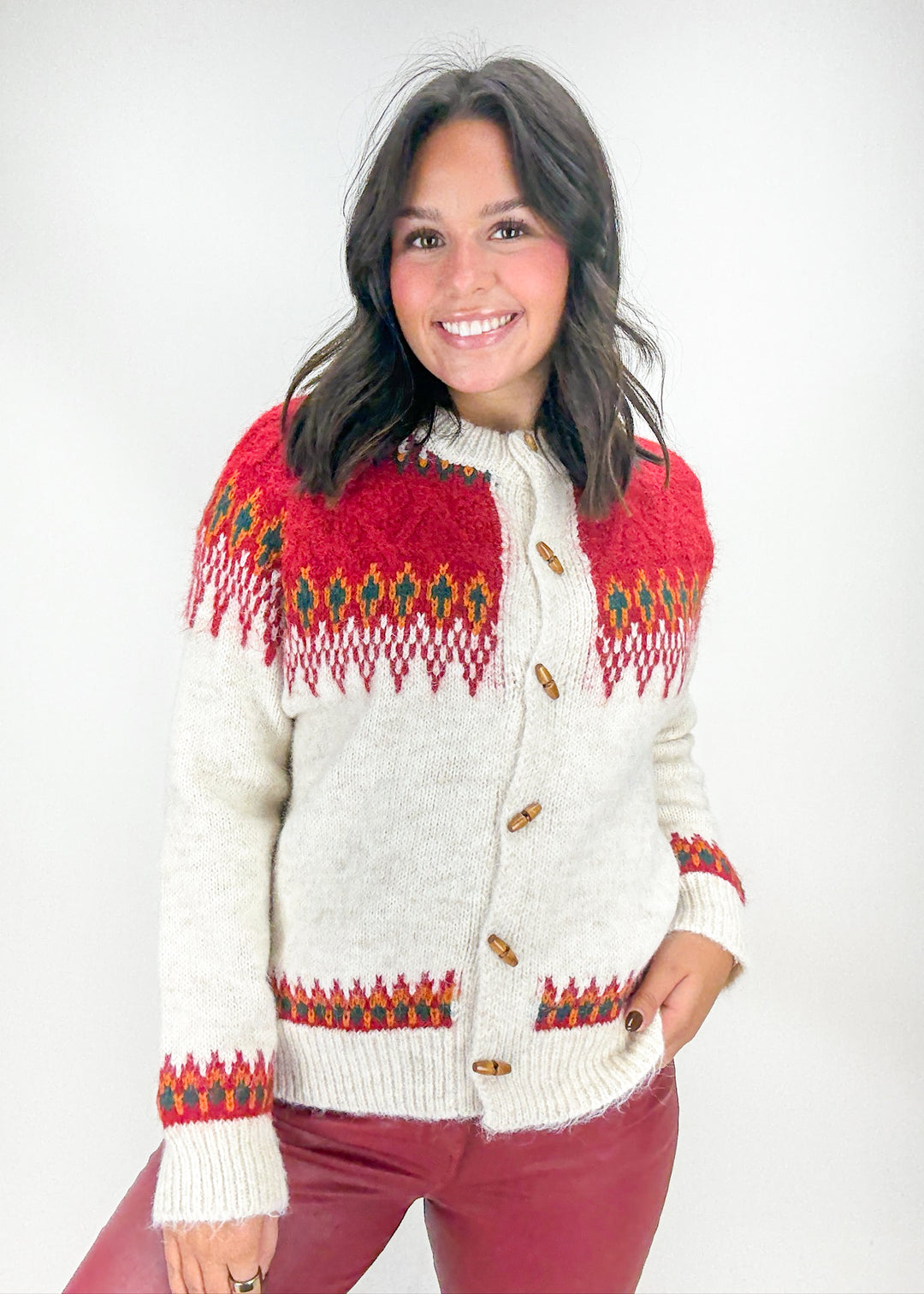 Woman wearing a red and white patterned sweater on a white background
