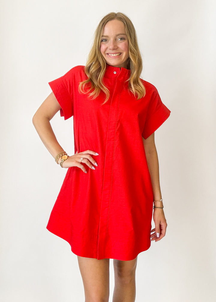Woman wearing a red dress against a white background