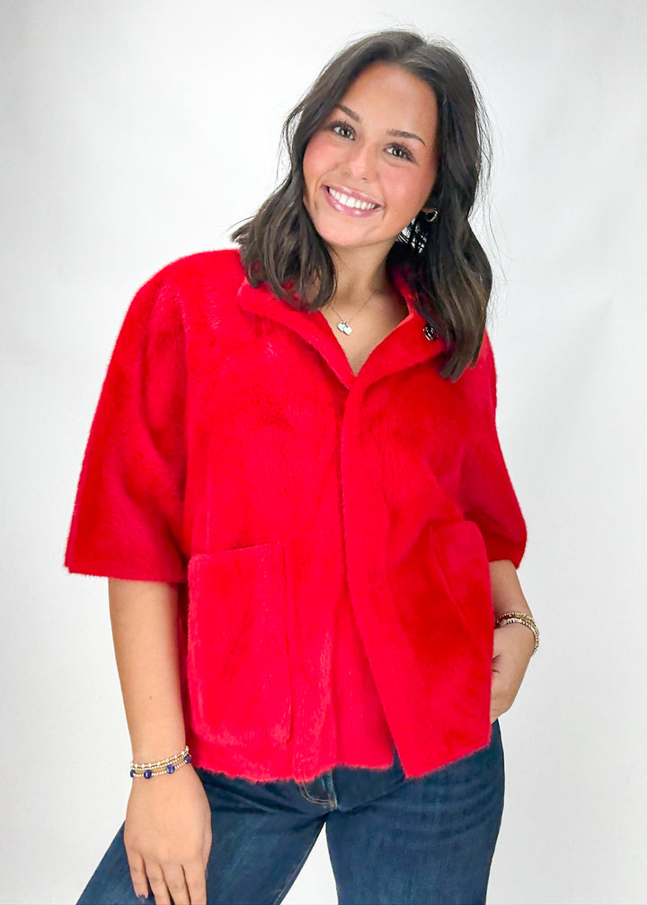Woman wearing a red jacket on a white background
